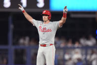 Philadelphia Phillies' J.T. Realmuto celebrates after he hit a ground rule double during the fourth inning of a baseball game against the Miami Marlins, Friday, May 10, 2024, in Miami. (AP Photo/Wilfredo Lee)
