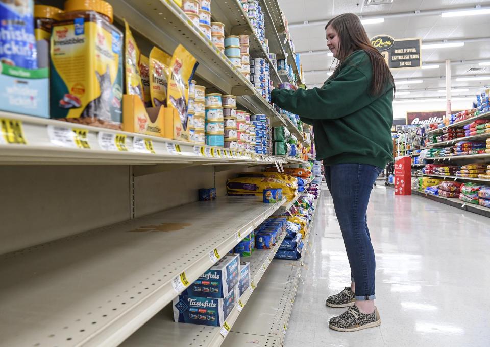Maddison Kelly of Quality Foods in Anderson looks at shelves with dry and wet cat food in Anderson, S.C. in January 2022. With some items like wet cat food limited in the supply chain to most stores, customers adjust to what is in stock.