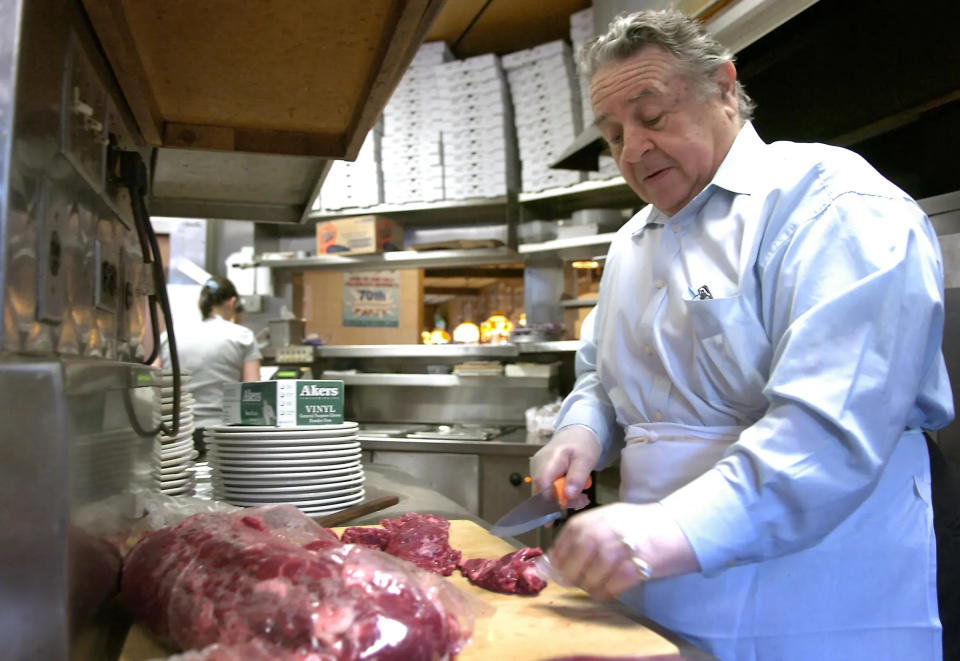 In this 2007 file photo, Charlie Tartaglia, owner of George's Cafe, cuts steak for steak tips in the kitchen while preparing to celebrate the George's Cafe 70th anniversary party at the landmark Belmont Street family-owned eatery. (J. KIELY JR./THE ENTERPRISE)