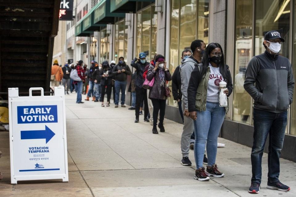 In this Oct. 1, 2020, file photo, hundreds of people wait in line to early vote in Chicago. (Ashlee Rezin Garcia/Chicago Sun-Times via AP, File)