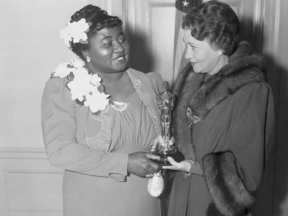 Twelfth Annual Banquet of the Academy of Motion Picture Arts and Sciences. Los Angeles, California: Actress Fay Bainter (right) presenting Hattie McDaniel (left) her award for her supporting role in Gone With the Wind. February 29, 1940.