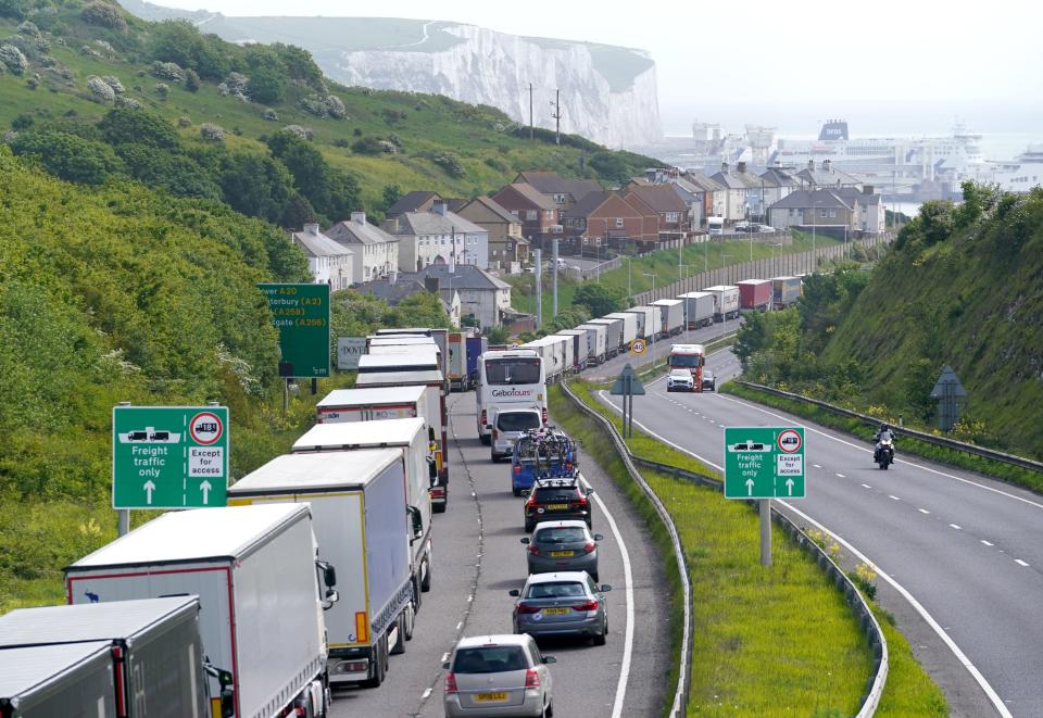 Lorries queue for the Port of Dover along the A20 in Kent as the getaway for half term and the bank holiday weekend begins (PA)