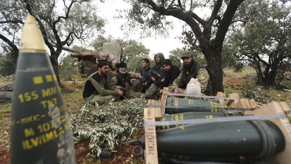 Turkish backed Syrian fighters take a break near the village of Neirab, in Idlib province, Syria, Monday, Feb. 24, 2020. (AP Photo/Ghaith Alsayed)