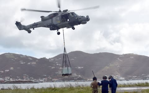 An MoD helicopter delivering aid in the British Virgin Islands during a relief operation following Hurricane Irma - Credit: AFP