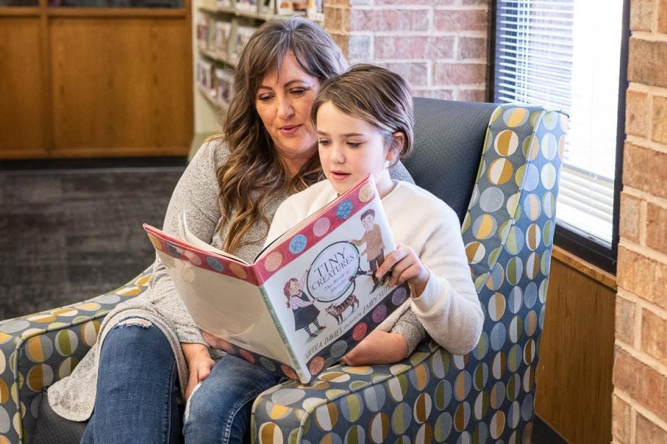 Noble resident Erika Wright and her daughter, Vivi Wright, read together at the public library after school on Jan. 6, 2022. Wright recently changed her voter registration from Independent to Republican to vote in the State Superintendents race this summer. She said education issues are too important not to use her voice.