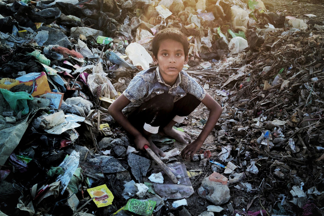 Absar, 6, sells plastic bottles he collects to support his family. (Sahat Zia Hero)