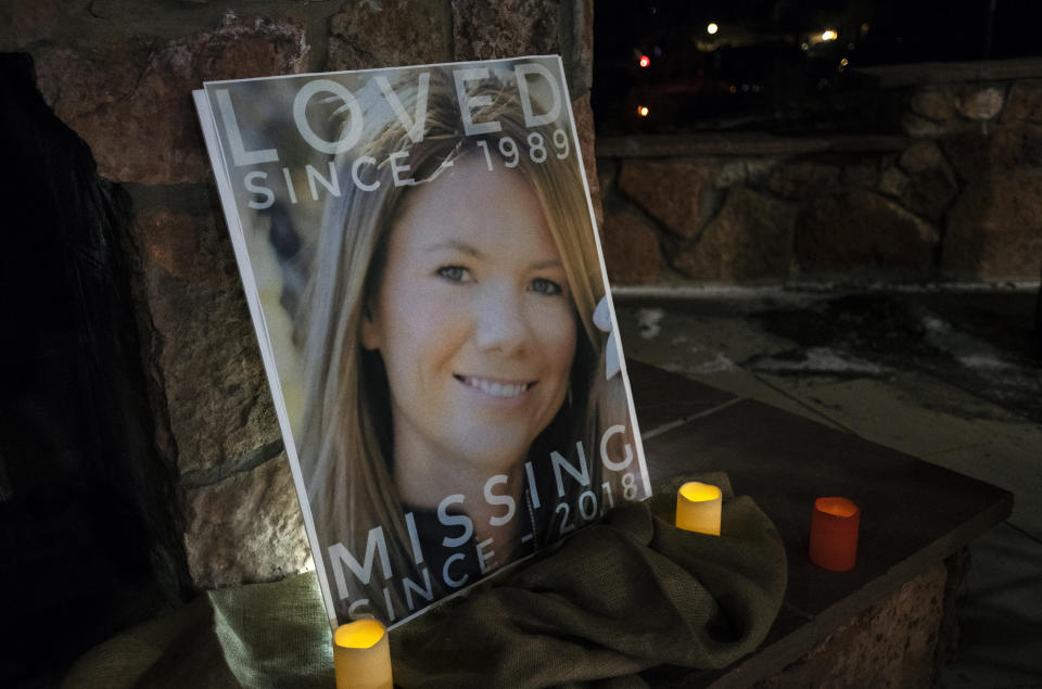 FILE - In this Dec. 13, 2018 file photo, a poster with the picture of missing Kelsey Berreth is propped up with candles for a vigil at Memorial Park in Woodland Park, Colo. Prosecutors will be permitted to conduct DNA testing on a tooth fragment found on the ranch of a Colorado man suspected of killing the mother of his child and burning her body, a judge ruled Friday, June 14, 2019. The Gazette reports that investigators discovered the fragment while searching a ranch owned by Patrick Frazee, who has pleaded not guilty to killing Kelsey Berreth. (Kelsey Brunner/The Gazette via AP, File)