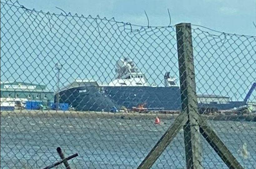 The research vessel Petrel leans against a dry dock in the Edinburgh suburb of Leith, in Scotland, March 22, 2023, after apparently being knocked over by strong winds. / Credit: Twitter / @Tomafc83