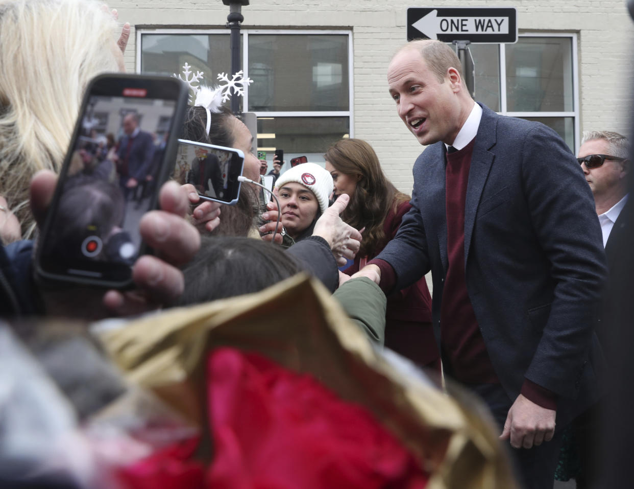 Britain's Prince William greets people in the crowd after a visit to Roca on Thursday, Dec. 1, 2022, in Chelsea, Ma. (Nancy Lane/The Boston Herald via AP, Pool)