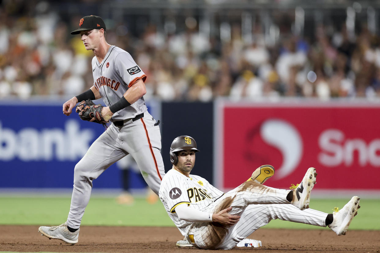 San Diego Padres' Tyler Wade, right, reacts after being forced out at second by San Francisco Giants shortstop Tyler Fitzgerald, who threw out Mason McCoy at first to complete a double play during the sixth inning of a baseball game Saturday, Sept. 7, 2024, in San Diego. (AP Photo/Ryan Sun)