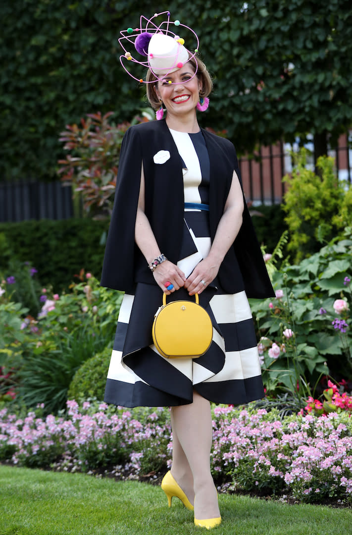 Sarah Soulsby from London brightened up her monochrome ensemble with a zesty handbag and co-ordinating shoes but it was her pom pom headpiece which really stole the conversation. <em>[Photo: Getty]</em>