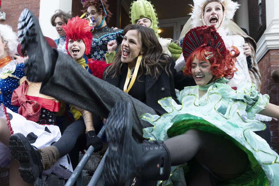 Jennifer Garner, center, performs a kick dance with members of Harvard University's Hasty Pudding Theatricals following a parade which honored her as "Woman of the Year", Saturday, Feb. 5, 2022, in Cambridge, Mass. (AP Photo/Michael Dwyer)