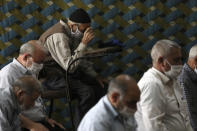 Worshippers wearing protective face masks to help prevent the spread of the coronavirus pray at a mosque in the the city of Zanjan, some 330 kilometers (205 miles) west of the capital Tehran, Iran, Sunday, July 5, 2020. Iran on Sunday instituted mandatory mask-wearing as fears mount over newly spiking reported deaths from the coronavirus, even as its public increasingly shrugs off the danger of the COVID-19 illness it causes. (AP Photo/Vahid Salemi)