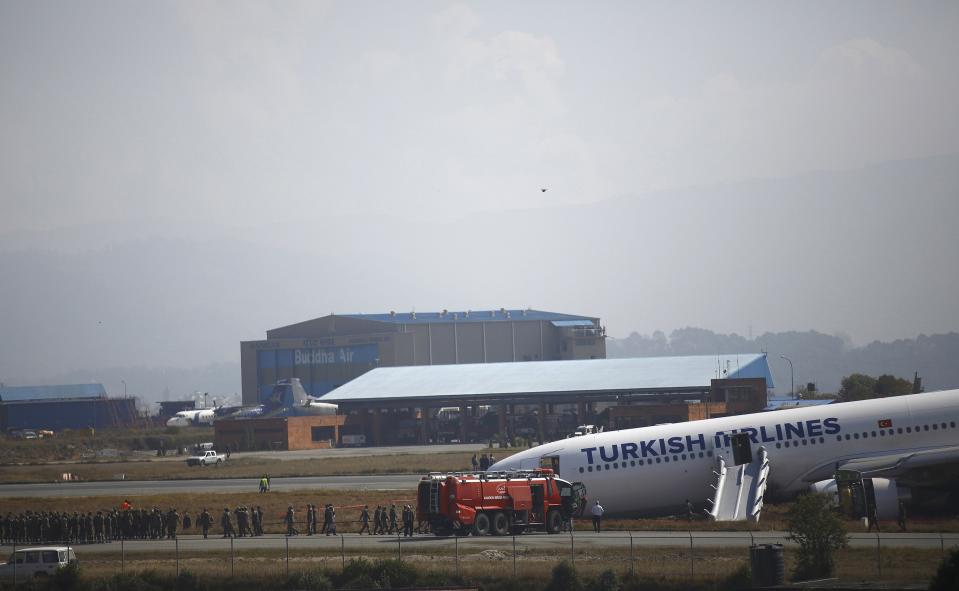 A Turkish Airlines plane lies on the field after it overshot the runway at Tribhuvan International Airport in Kathmandu