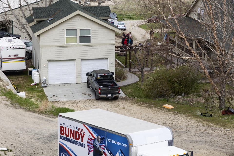 FILE - Supporters gather on the property of former Idaho gubernatorial candidate and far-right activist Ammon Bundy after law enforcement officers attempted to arrest Bundy on a misdemeanor warrant for contempt of court earlier in the day, on Monday, April 24, 2023, in Emmett, Idaho. Bundy was not home at the time, and the officers left. The contempt warrant came in a defamation lawsuit brought against Bundy and others by a regional hospital system. (AP Photo/Kyle Green, File)