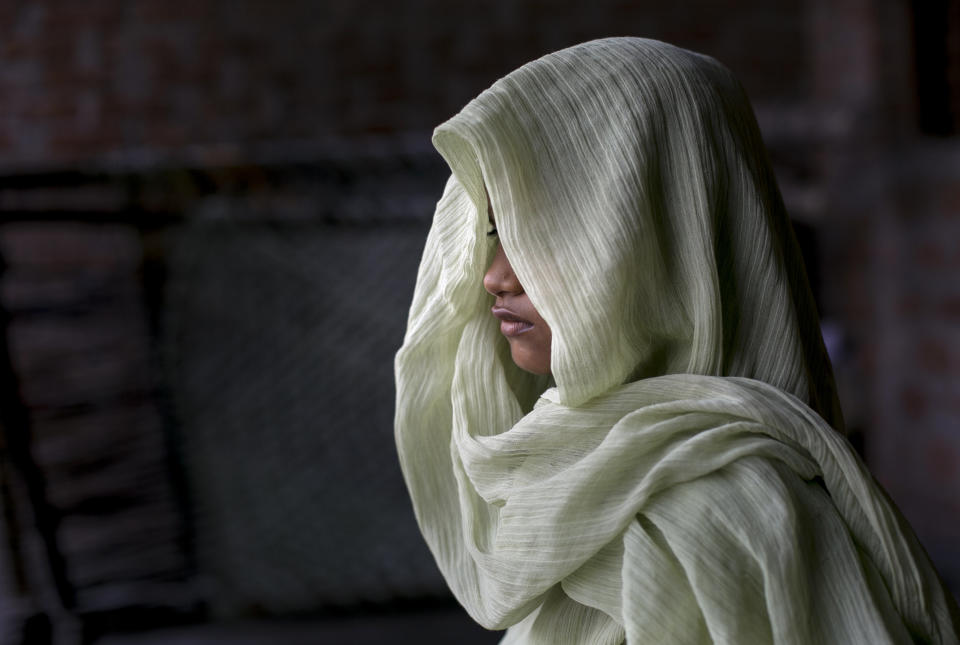 UTTAR PRADESH, INDIA - SEPTEMBER 9: 7 year old Dipti (name changed) poses for a photo on her roof, where she was raped two years ago, on September 9, 2016 in Uttar Pradesh, India. Two years ago, when she was 4 years old, she was raped by a neighbor, who the family says is about 27 years old now. The rape happened when her mother was at the market and her father was taking a shower. The neighbor found her playing up on the roof of her house and he raped her. Her father came up after his shower and asked her why her pants were wet, and she told him what happened to her. He took her to the police station where they registered a case. Her family asked the police for medical treatment for her, but the police responded 'your daughter looks fine, all we need is her pants for the investigation.'. Her family says that the community is torn, many people support them, but many others sympathize with the rapist because he is the only male of the family, and if he goes to jail they say no one will be able to financially support his family. He was in jail for 1 and 1/2 years, but now he is out on bail, and has offered the family 80,000 rupees (about $1195) to drop the case. After the rape, Dipti stayed home from school for 15 days because people were approaching her on the road to school, threatening that they would attack her brother unless her family dropped the case. (Photo by Getty Images)