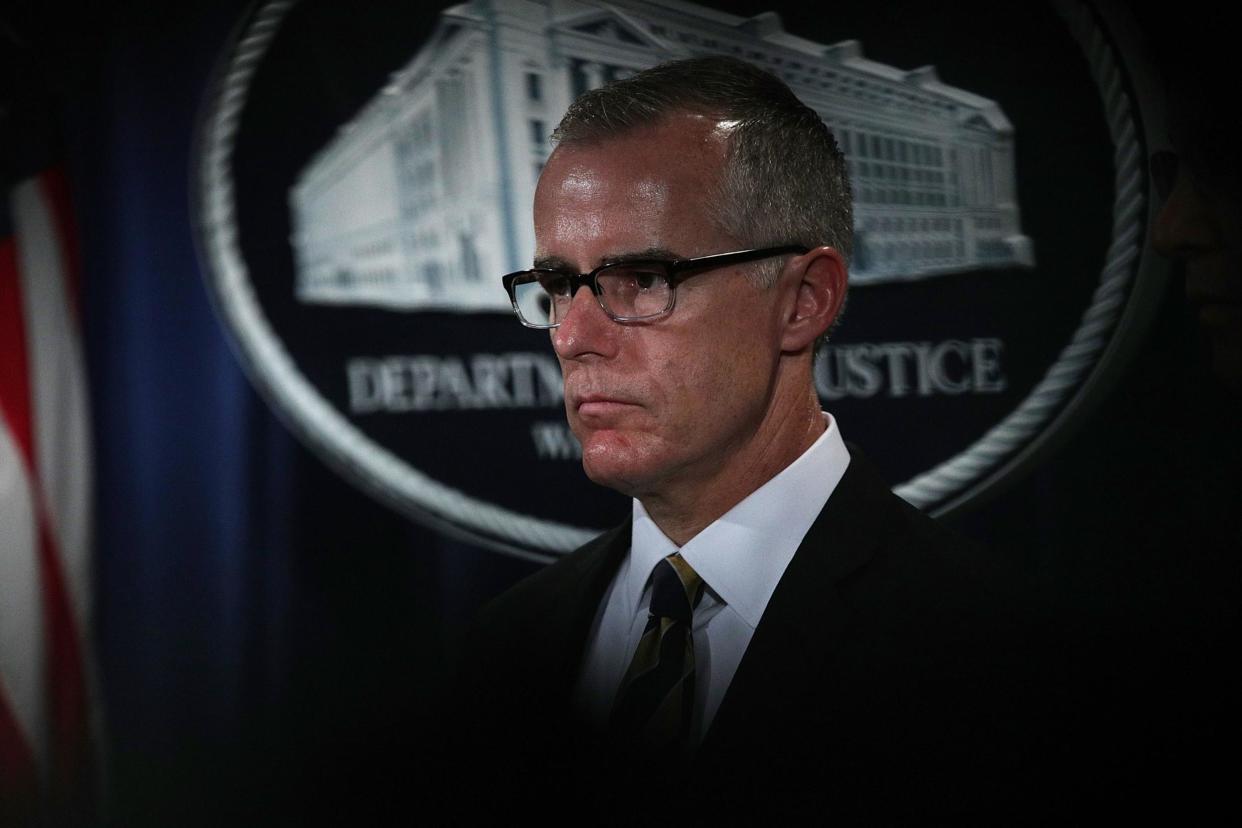 Andrew McCabe listens during a news conference to announce significant law enforcement actions: Getty