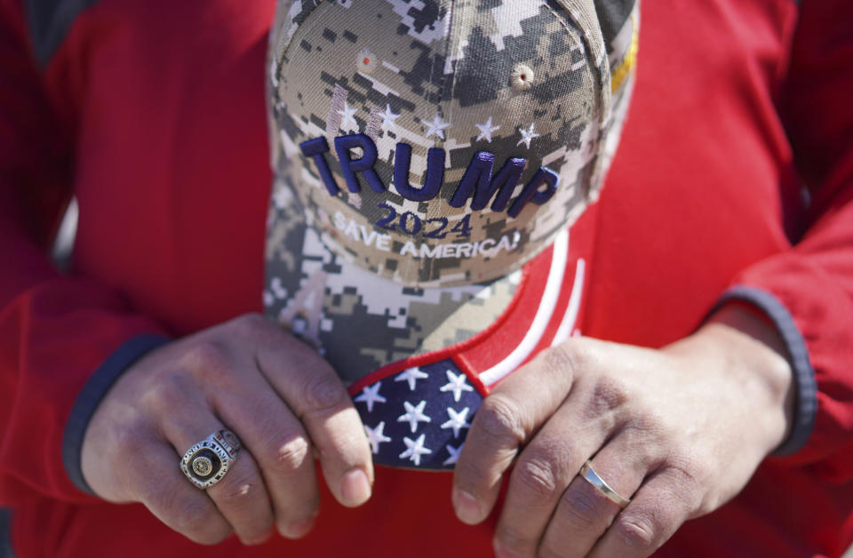 Philip Hinson, a Southern Baptist, holds a Trump 2024 hat in his hands at the former president's campaign rally in Vandalia, Ohio, on Saturday, March 16, 2024. (AP Photo/Jessie Wardarski)