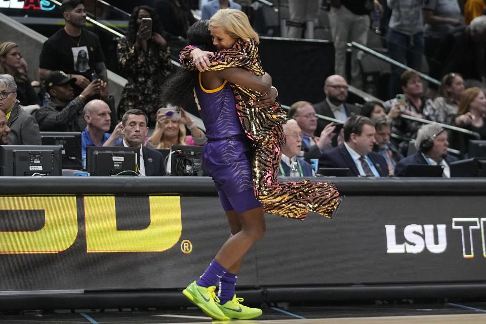 LSU head coach Kim Mulkey celebrates with Flau'jae Johnson during the second half of the NCAA Women's Final Four championship basketball game against Iowa Sunday, April 2, 2023, in Dallas. LSU won 102-85 to win the championship. (AP Photo/Darron Cummings)