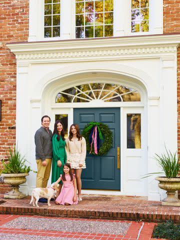 <p>James Ransom; Styling: Jennifer DeCleene</p> The Prichards with their dog, Honey, by the teal-painted front door (Benjamin Moore Newburg Green, HC-158)