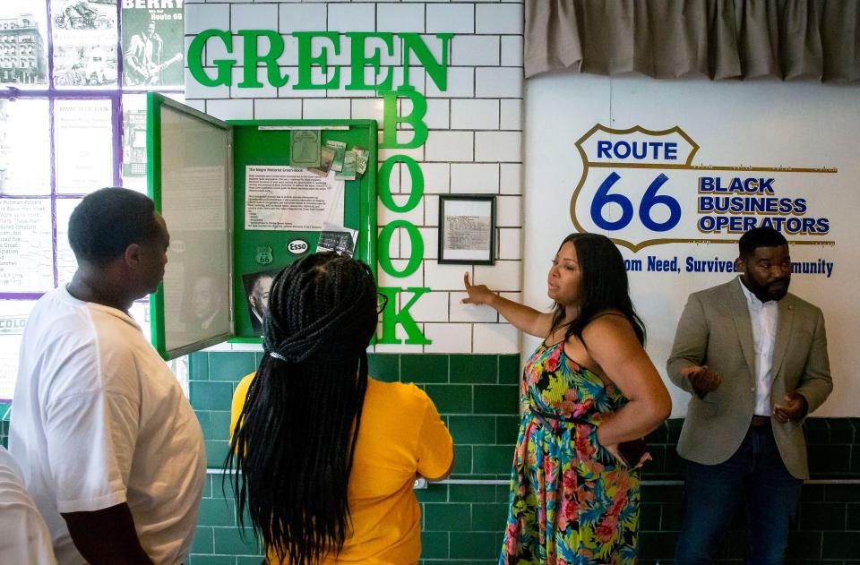 Stacey Grundy describes the Negro Motorist Green-Book exhibit feature inside the Route History museum and visitors center city in Springfield, Ill., Friday, July 9, 2021. The Negro Motorist Green-Book provided a list of hotels, guest houses, service stations, drug stores, taverns, barber shops and restaurants that were known to be safe ports for Black travelers during the Jim Crow-era of the United States. Route History highlights stories around the Black experience on historic Route 66 and is located on East Cook Street. [Justin L. Fowler/The State Journal-Register]