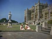 <p>Princess Elizabeth and Princess Margaret catch some rays on the lawn during their time at Windsor Castle in July of 1941. While the sisters spent a great deal of time at Windsor, their parents — King George VI and Queen Elizabeth — would visit on occasional evenings and weekends. </p>