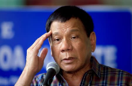 FILE PHOTO: Philippines' President Rodrigo Duterte answer questions during a press briefing after awarding wounded soldiers, who fight against the insurgents of the Maute group, which has taken over large parts of the Marawi city, during his visit at the military camp hospital in Cagayan De Oro, Philippines June 11, 2017. REUTERS/Romeo Ranoco/File photo