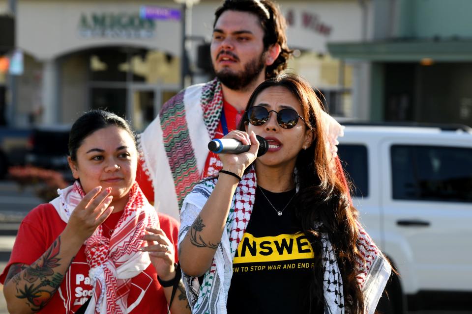 Laney Yompian, of anti-war group ANSWER Coalition, leads a series of group chants at Plaza Park in Oxnard on Wednesday during a Workers Unite for Palestine rally.
