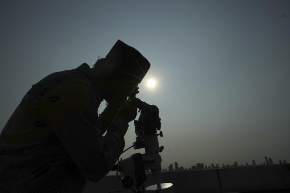 An official is silhouetted as he uses a telescope to scan the horizon for a crescent moon that will determine the beginning of the holy fasting month of Ramadan in Jakarta, Indonesia, Wednesday, March. 22, 2023. Millions of Muslims in Indonesia are gearing up to celebrate the holy month of Ramadan, which is expected to start on Thursday, with traditions and ceremonies across the world's most populous Muslim-majority country amid soaring food prices.(AP Photo/Achmad Ibrahim)