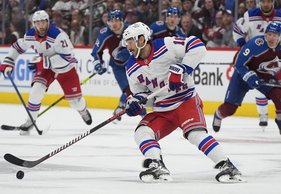 New York Rangers center Vincent Trocheck collects the puck during the second period of the team's NHL hockey game against the Colorado Avalanche on Thursday, March 28, 2024, in Denver. (AP Photo/David Zalubowski)