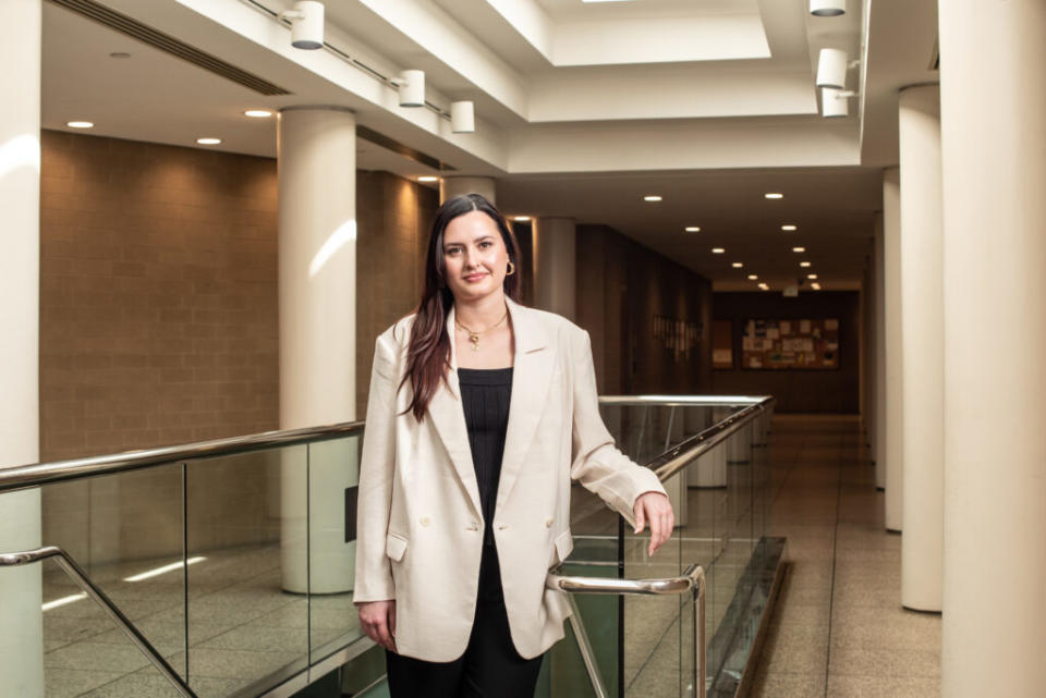 A woman in a suit near a bannister