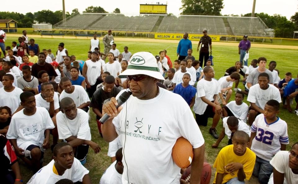 Jimmy Raye speaks to young players during the Jimmy Raye Youth Foundation football camp at E.E. Smith in 2007.