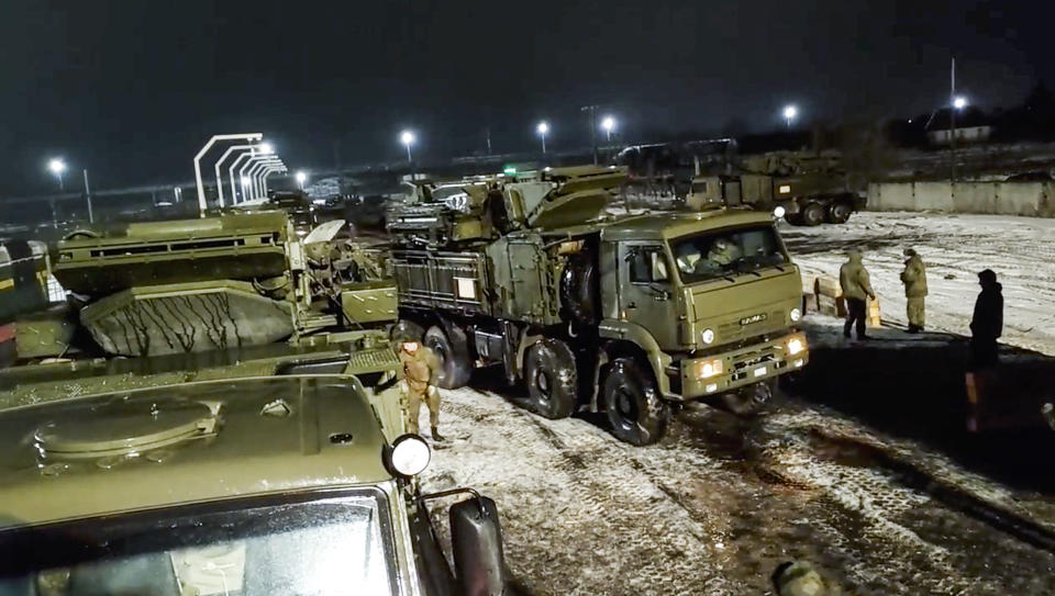 In this photo taken from video provided by the Russian Defense Ministry Press Service on Saturday, Jan. 29, 2022, A Russian military vehicle drive off a railway platforms after arrival in Belarus. In a move that further beefs up forces near Ukraine, Russia has sent an unspecified number of troops from the country's far east to its ally Belarus, which shares a border with Ukraine, for major war games next month. (Russian Defense Ministry Press Service via AP)