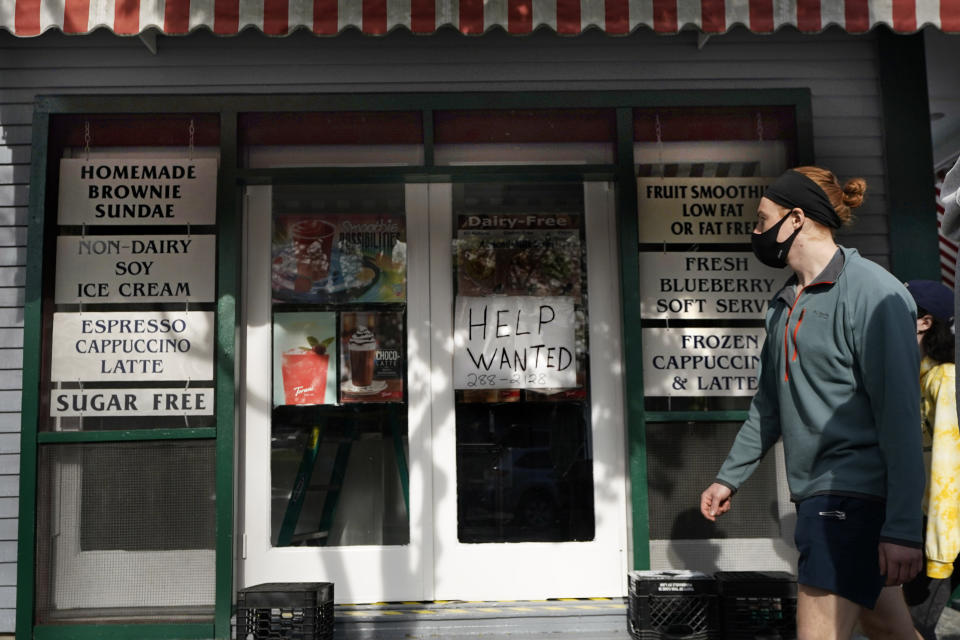 An ice cream shop advertises for help Saturday, May 15, 2021, in Bar Harbor, Maine. America’s tourist destinations are facing a severe worker shortage just as they try to rebound from a devastating year lost to the pandemic. (AP Photo/Robert F. Bukaty)