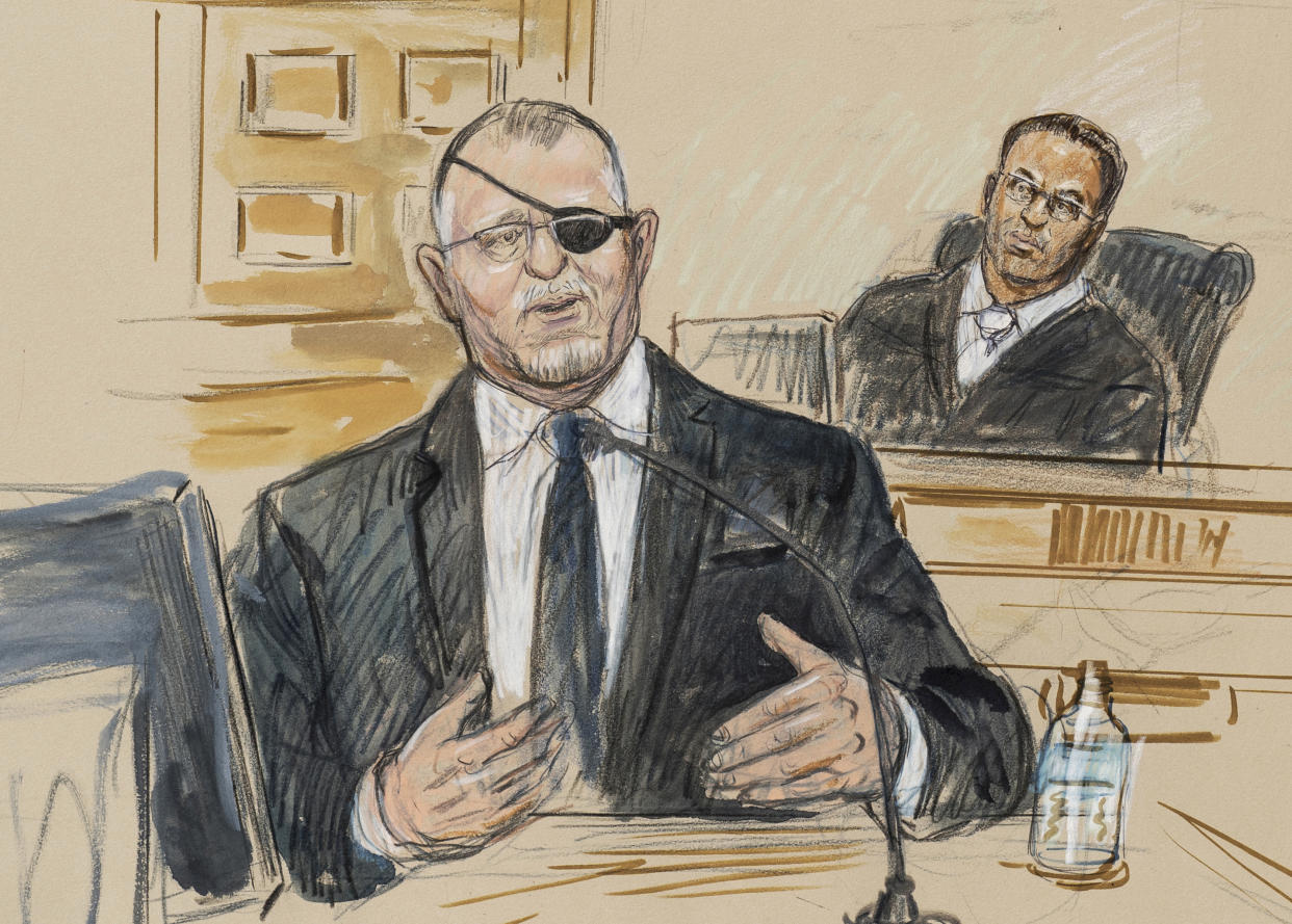 FILE - This artist sketch depicts the trial of Oath Keepers leader Stewart Rhodes, left, as he testifies before U.S. District Judge Amit Mehta on charges of seditious conspiracy in the Jan. 6, 2021, attack on the U.S. Capitol, in Washington, Nov. 7, 2022. Rhodes will be sentenced Thursday, May 25, 2023, after a landmark verdict convicting him of a spearheading a weekslong plot to keep former President Donald Trump in power, culminating in far-right extremists attacking the U.S. Capitol on Jan. 6, 2021. (Dana Verkouteren via AP, File)