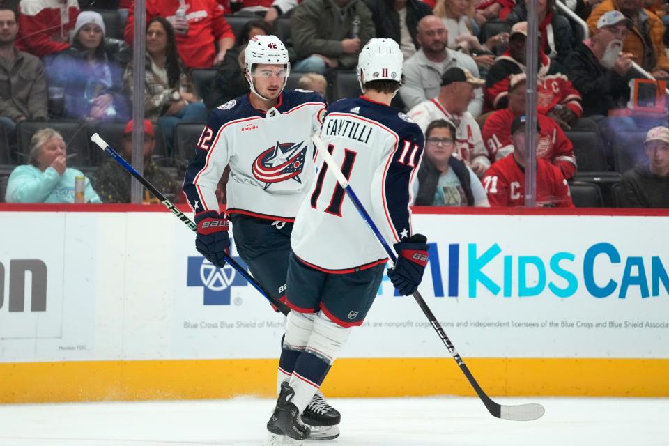 Columbus Blue Jackets center Alexandre Texier (42) celebrates his goal with Adam Fantilli (11) against the Detroit Red Wings in the first period of an NHL hockey game Saturday, Nov. 11, 2023, in Detroit. (AP Photo/Paul Sancya)