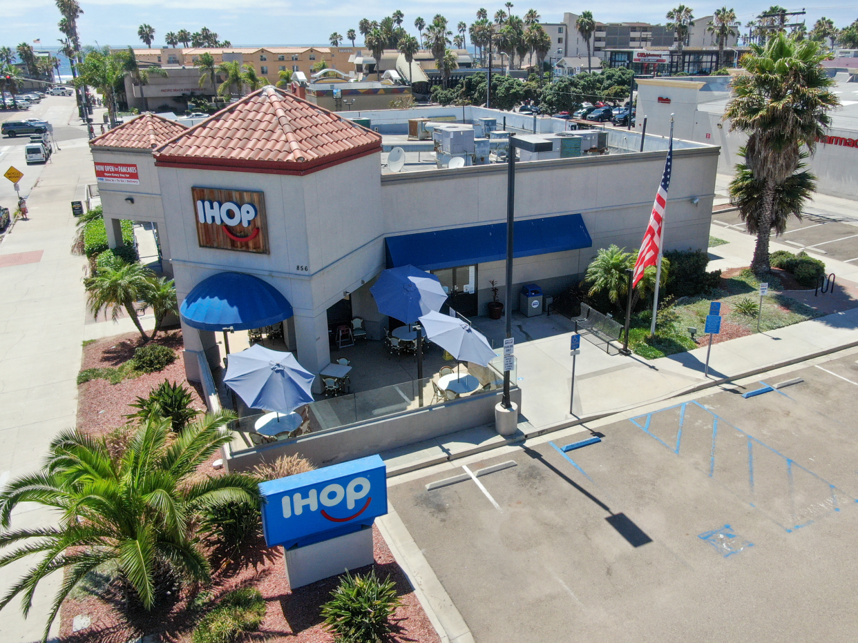 Aerial of Front Exterior of IHOP, Pacific Beach, California, With Sidewalk and Parking Lot