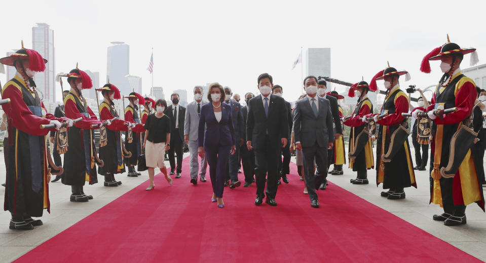 U.S. House Speaker Nancy Pelosi, center left, and South Korean National Assembly Speaker Kim Jin Pyo, center right, inspect an honor guard upon her arrival at the National Assembly in Seoul, South Korea, Thursday, Aug. 4, 2022. (Lee Jung-hoon/Yonhap via AP)