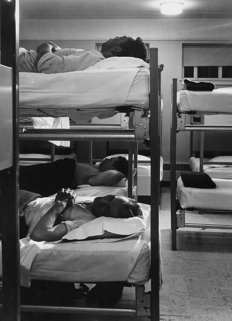 Men prepare for a good night's sleep in bunk beds in 1958 at the Haven of Rest in Akron.