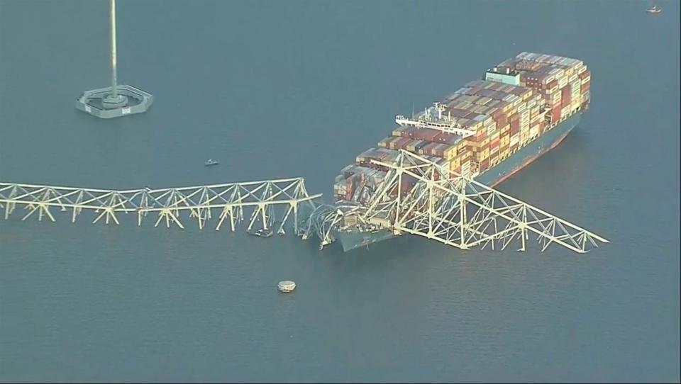 Parts of the Francis Scott Key Bridge remain after a container ship collided with a support Tuesday, March 26, 2024 in Baltimore. The major bridge in Baltimore snapped and collapsed after a container ship rammed into it early Tuesday, and several vehicles fell into the river below. Rescuers were searching for multiple people in the water. (WJLA via AP)