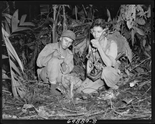 Spears’s grandfather George Kirk, right, operating a portable radio in the South Pacific, 1943. (National Archives)