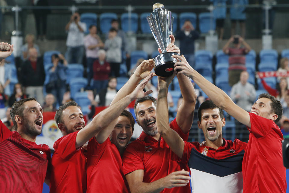 Serbia players hold up the ATP CUP after defeating Spain during their ATP Cup tennis tournament in Sydney, Monday, Jan. 13, 2020. (AP Photo/Steve Christo)