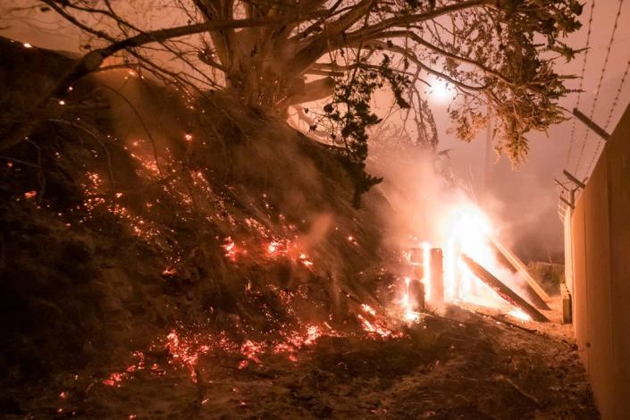 The Colorado Fire burns a fence off Highway 1 near Big Sur, Calif., Saturday, Jan. 22, 2022. (AP Photo/Nic Coury) (AP)