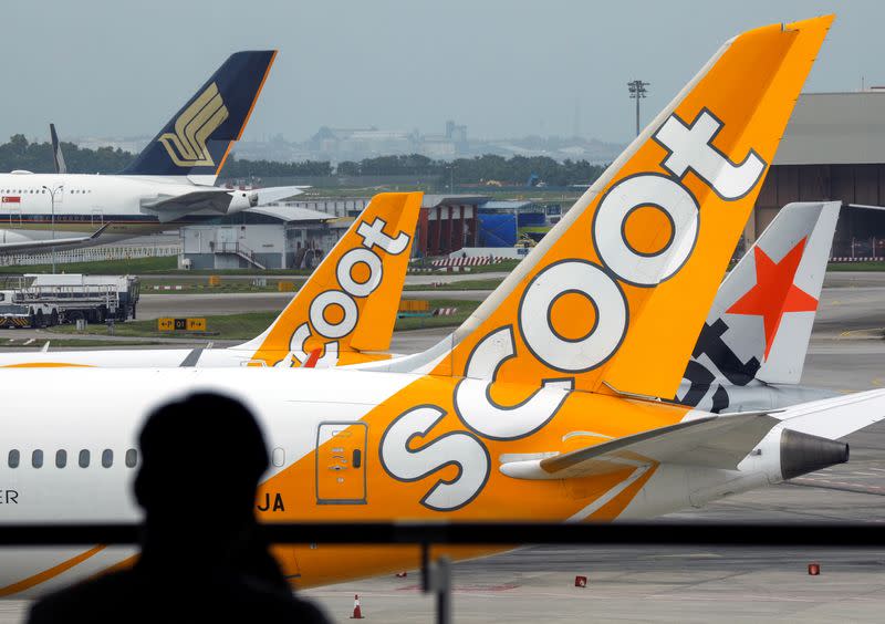 Scoot, Jetstar and Singapore Airlines planes sit on the tarmac at Singapore's Changi Airport