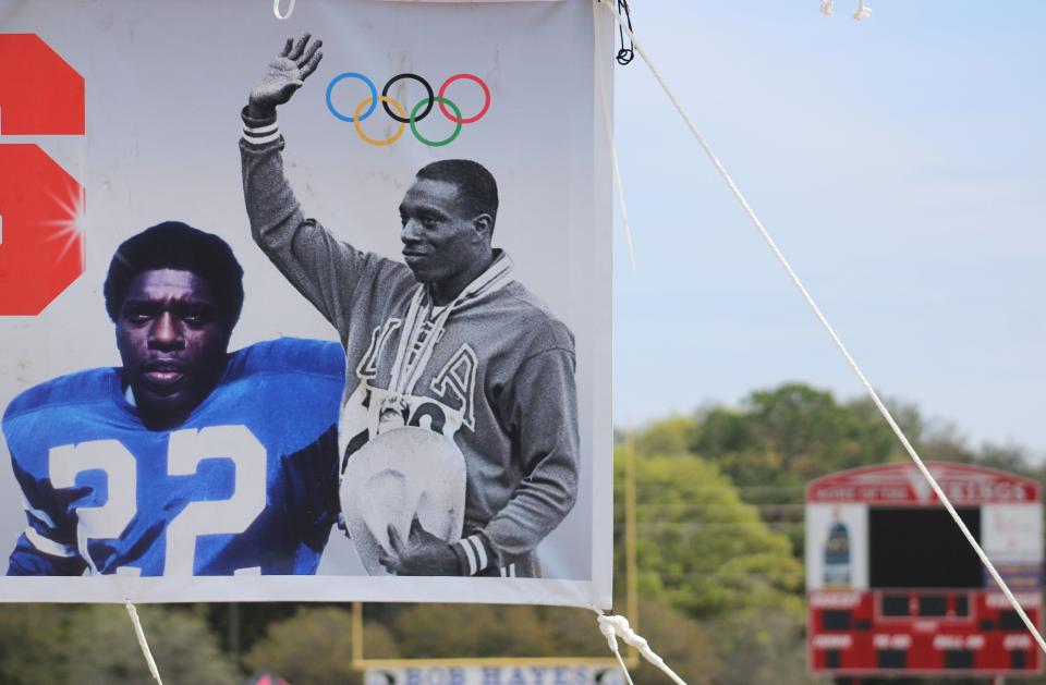 A banner pictures former Olympic sprint champion and Hall of Fame wide receiver Bob Hayes at Raines High School before the Bob Hayes Invitational Track Meet on March 16, 2021. [Clayton Freeman/Florida Times-Union]