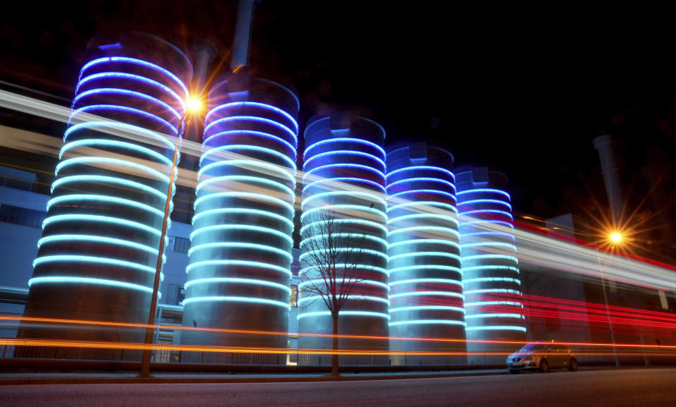 A bus passes by the Adlershof gas-fired power plant, in Berlin, Germany, Wednesday, March 30, 2022. Germany and Austria have activated early warning plans amid concerns that Moscow could cut natural gas deliveries. Together with France, they also urged consumers to conserve energy. (AP Photo/Michael Sohn)