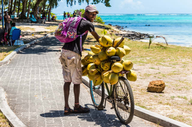 Man selling coconuts from his bike