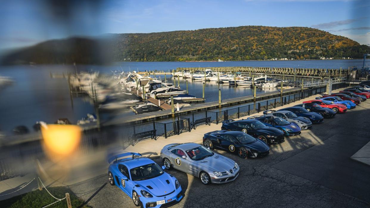 a parking lot with cars parked by a body of water