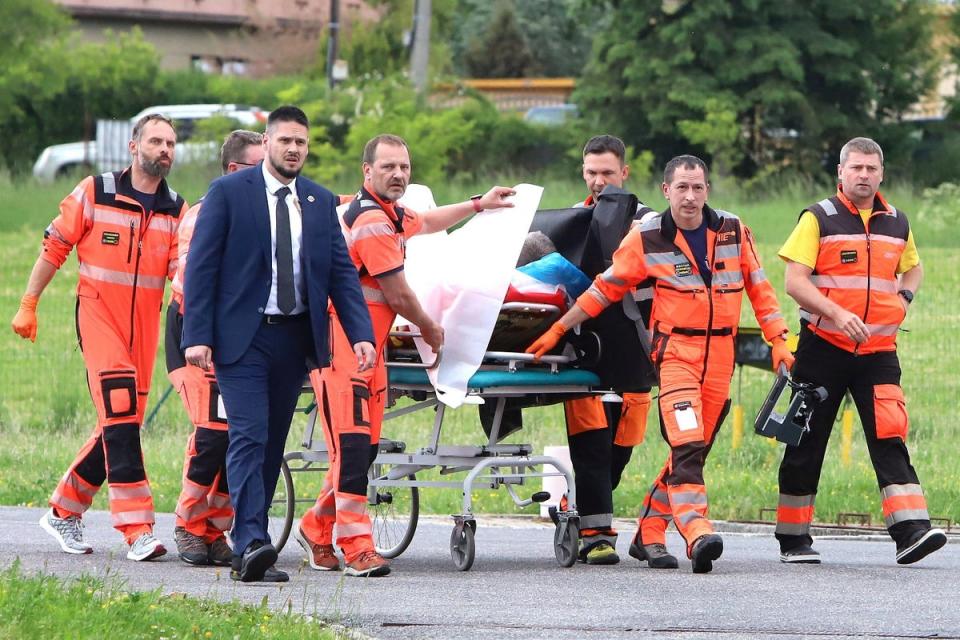 Rescue workers wheel shot Slovak Prime Minister Robert Fico to a hospital in the town of Banska (Tlačová agentúra SR)