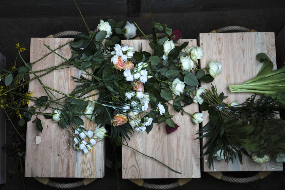 A view of caskets containing bones found on the grounds of the Freie Universitat, Free University ahead of burial, at the Waldfriedhof in Berlin, Germany, Thursday, March 23, 2023. Thousands of bone fragments found in the grounds of a Berlin university where an institute for anthropology and eugenics was once located, which may include the remains of victims of Nazi crimes, were buried on Thursday. (AP Photo/Markus Schreiber)